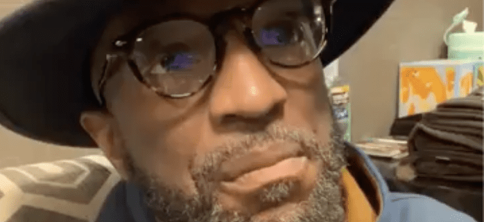 Man wearing glasses and a hat indoors.